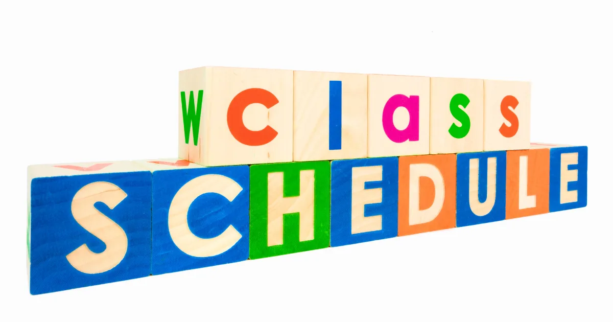 Wooden letter blocks arranged to spell “class schedule,” with “class” on the top row and “SCHEDULE” on the bottom row, in colorful letters on a white background—perfect for visual schedules.